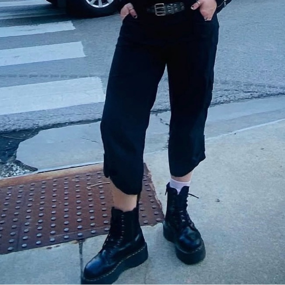 Black 3/4 pants with buttons on the bottom.